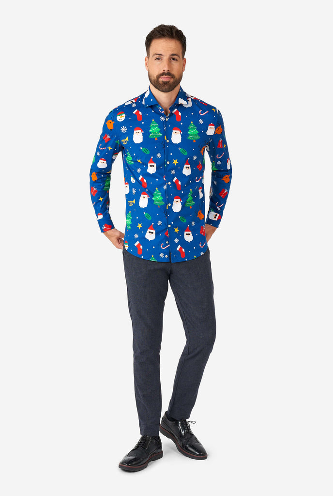 Man wearing blue Christmas dress shirt with Christmas icons