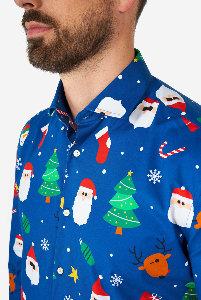 Man wearing blue Christmas dress shirt with Christmas icons, close up