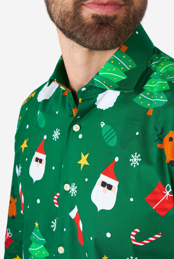 Man wearing green Christmas dress shirt with Christmas icons, close up