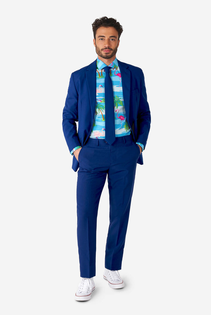 Man wearing Hawaiian dress shirt with tropical flamingo print an blue men's suit