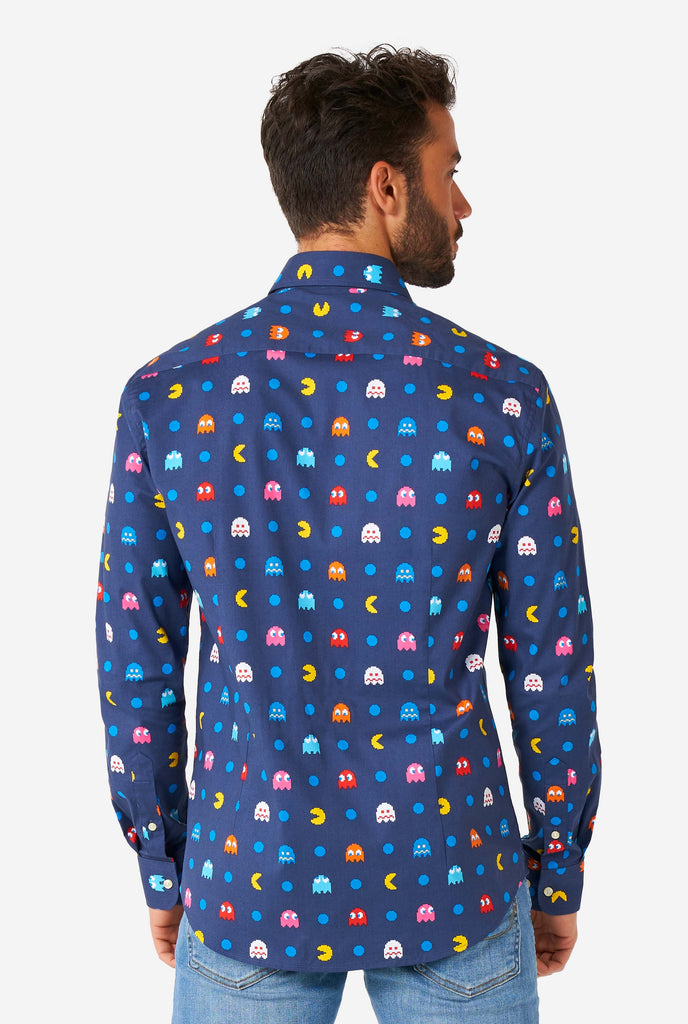 Man wearing blue dress shirt with Pac-Man icons, view from the back