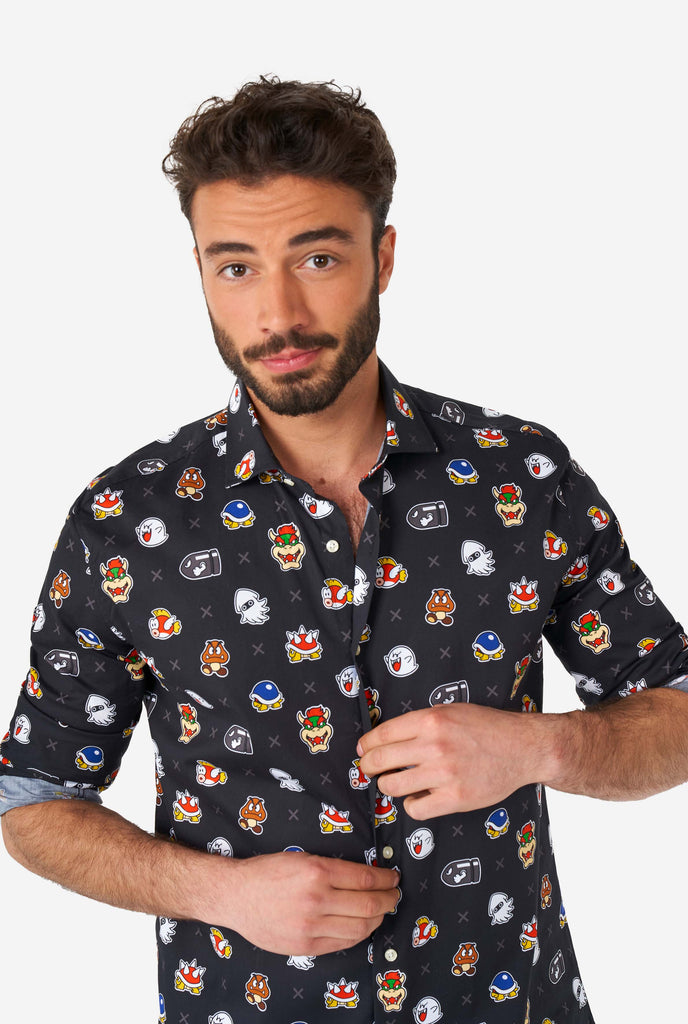 Man wearing black dress shirt with Super Mario bad guys icons