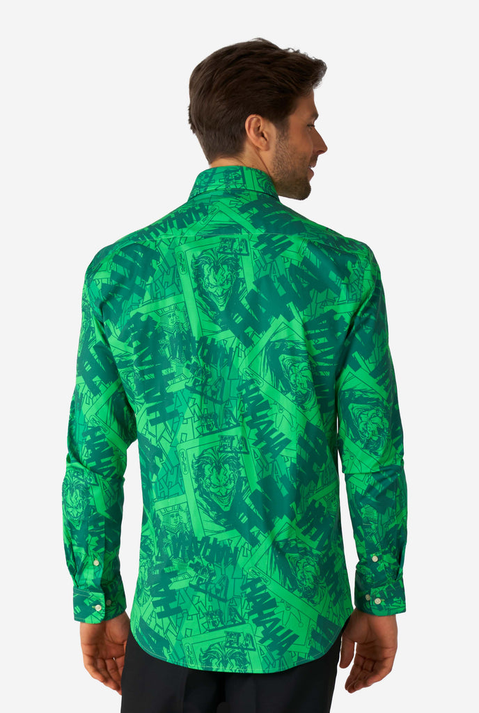 Man wearing green dress shirt with The Joker print, view from the back