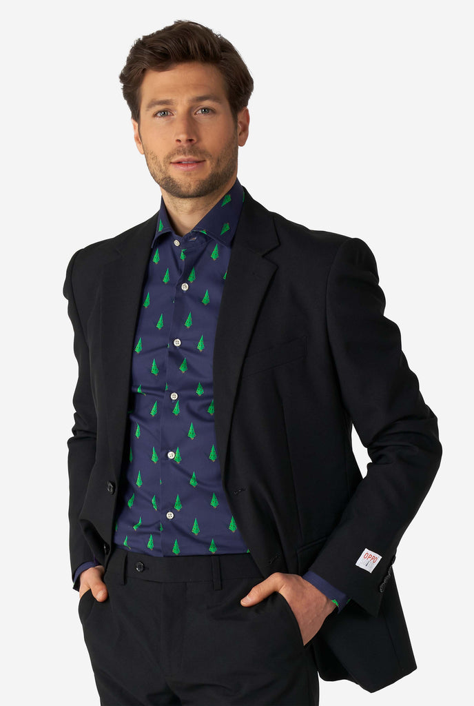 Man wearing blue dress shirt with Christmas tree print and black men's suit