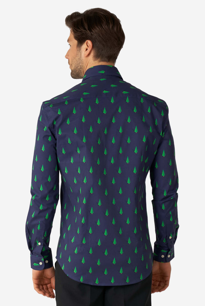 Man wearing blue dress shirt with Christmas tree print, view from the back