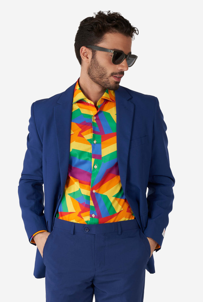 Man wearing colorful rainbow pride dress shirt and blue men's suit