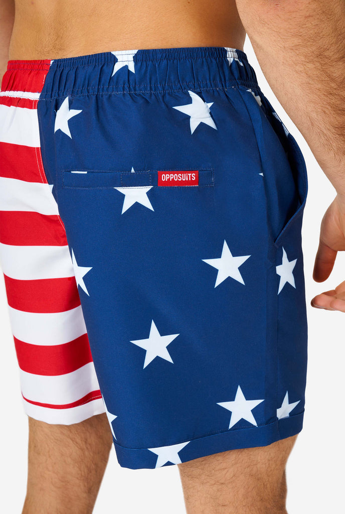 Man wearing summer outfit, consisting of shirt and shorts, with USA flag print, shorts close up