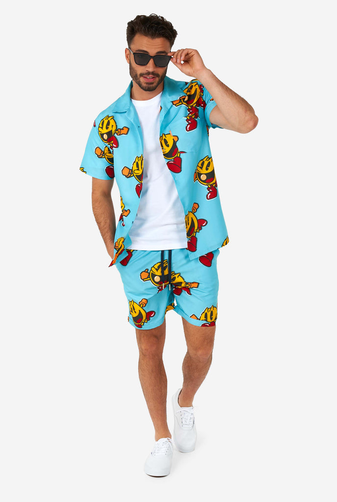 Man wearing blue summer shorts and shirt, with Pac-Man print