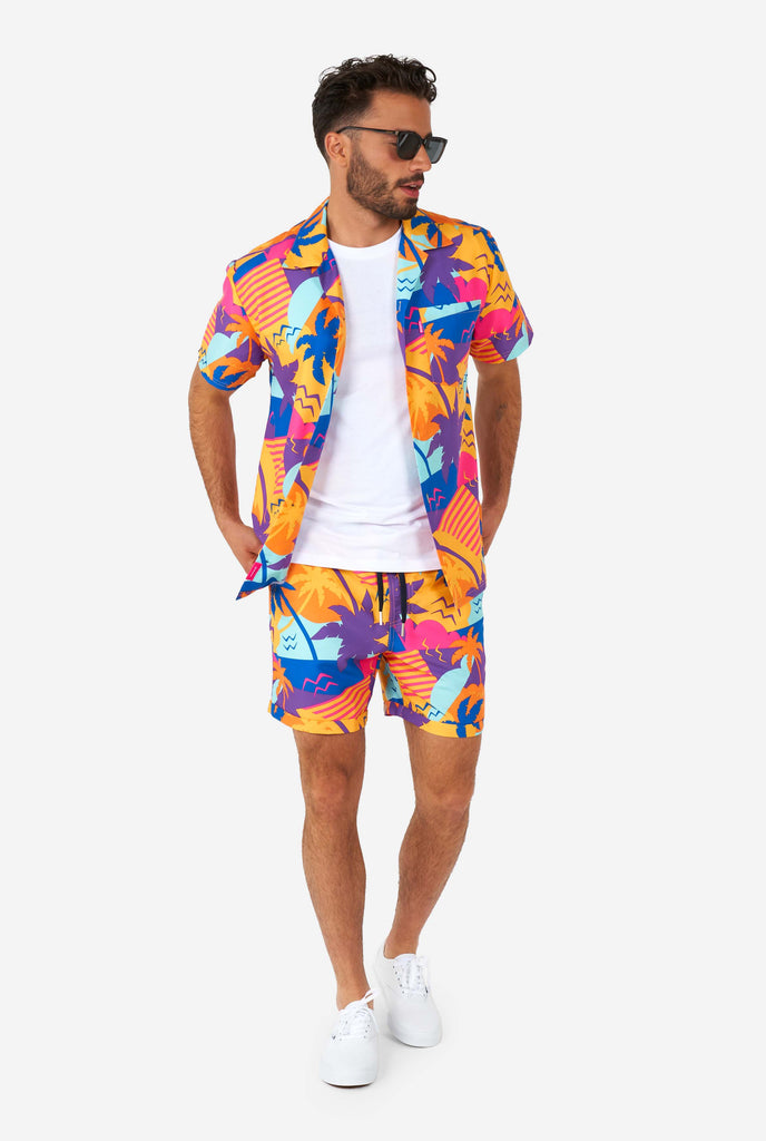 Man wearing colorful summer shorts and shirt