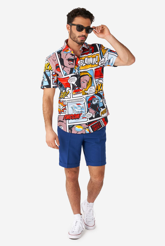 Man wearing summer shirt with Comic book print and blue shorts