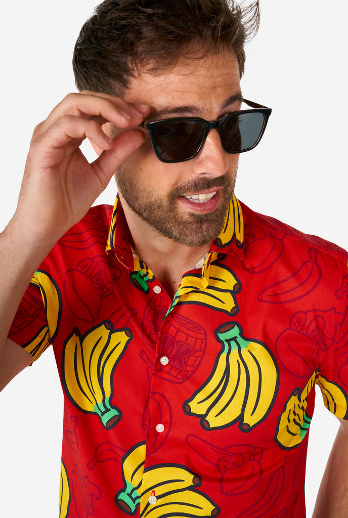 Man wearing red summer shirt with Donkey Kong print, close up