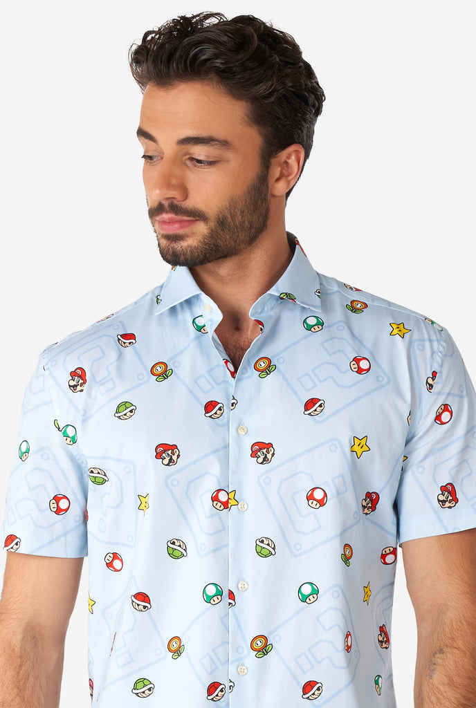 Men wearing blue summer shirt with Super Mario icons, close up