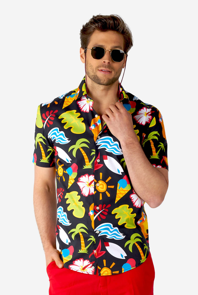 Man wearing black summer shirt with tropical icons and red short