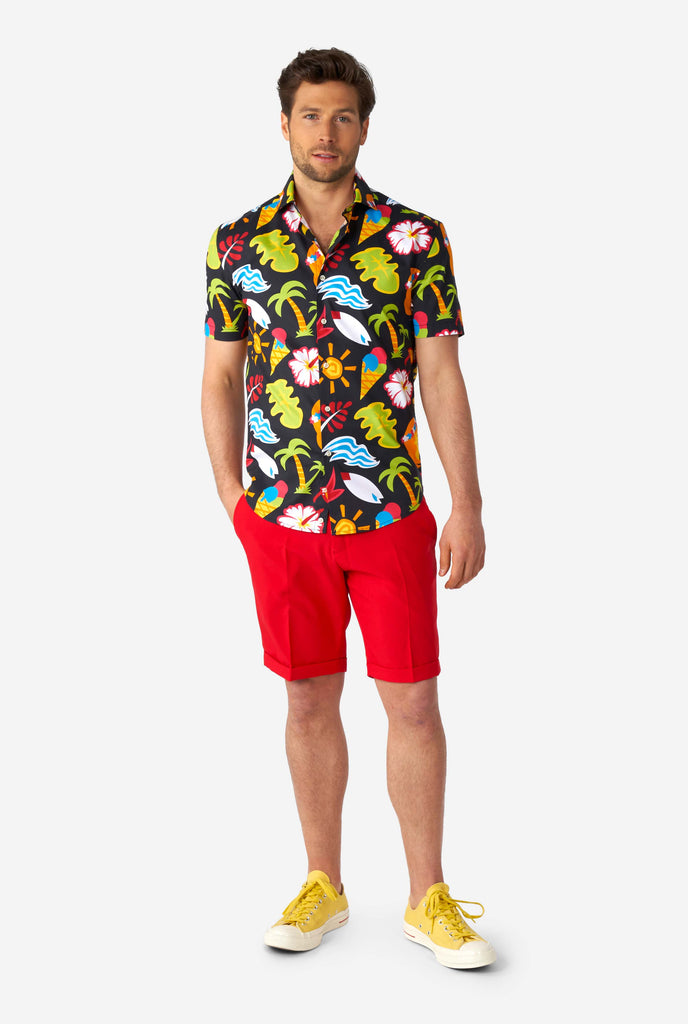 Man wearing black summer shirt with tropical icons and red short