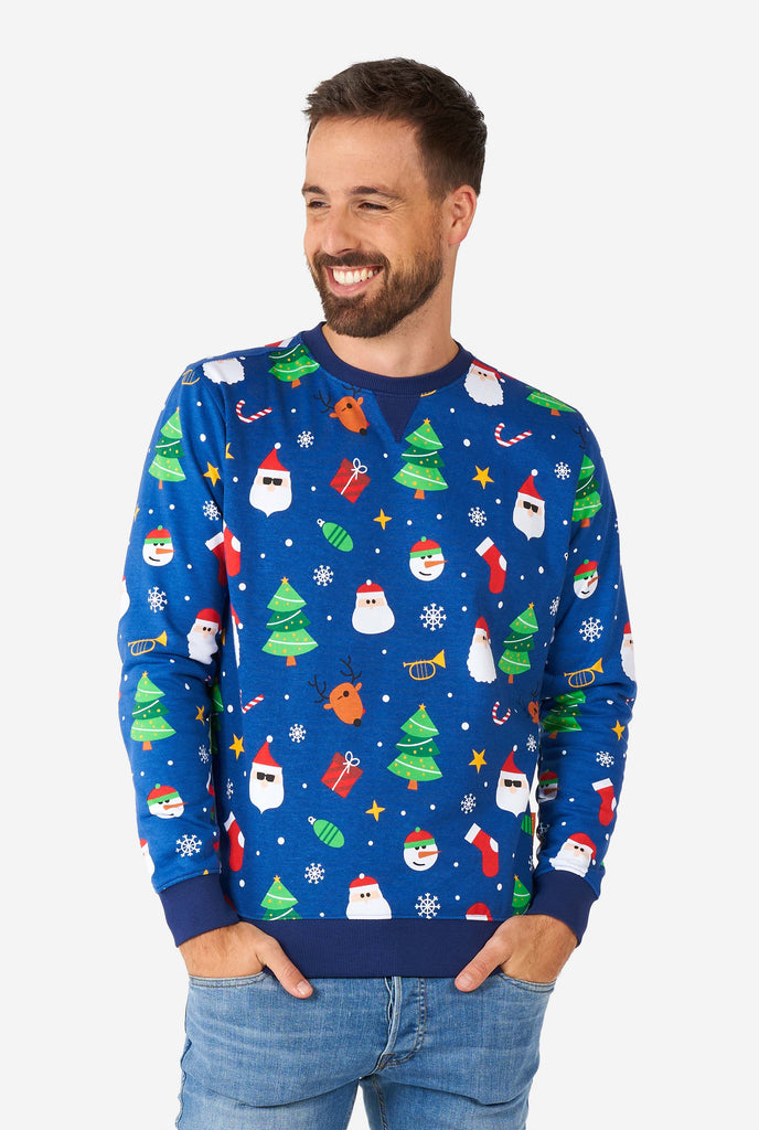 Man wearing blue Christmas sweater with Christmas icons