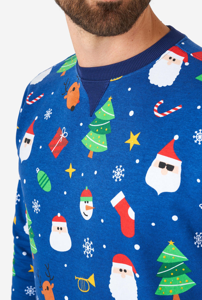 Man wearing blue Christmas sweater with Christmas icons, close up