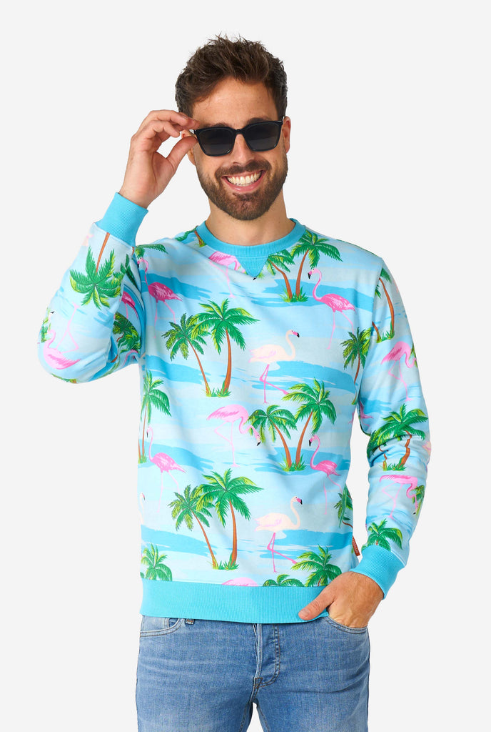 Man wearing blue sweater with tropical flamingo print