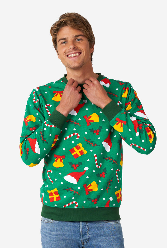 Man wearing green Christmas sweater with Christmas icons