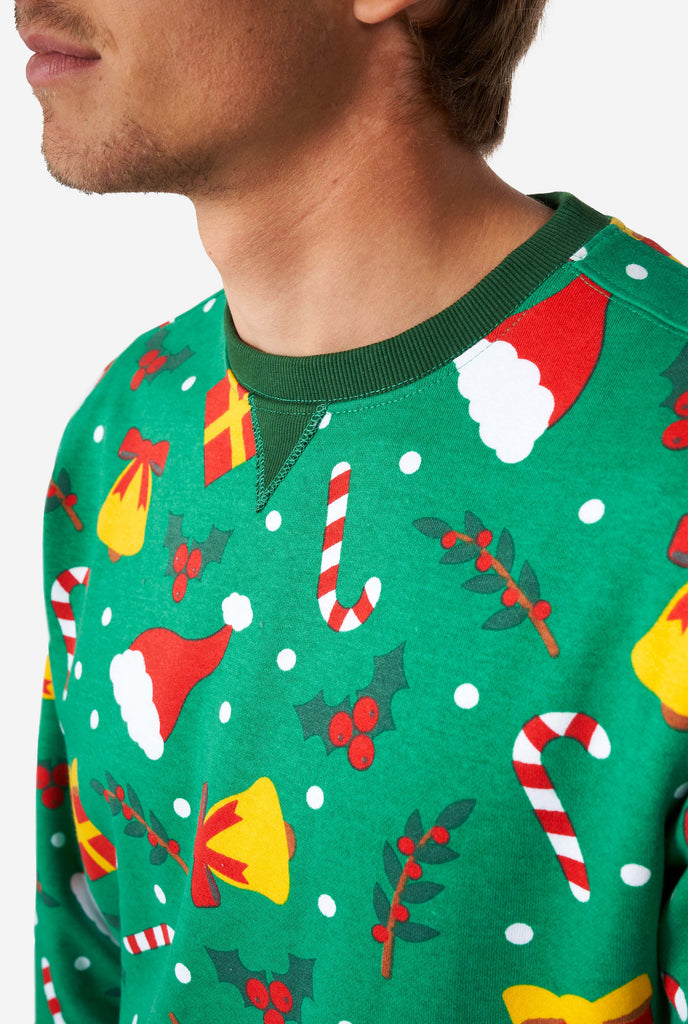 Man wearing green Christmas sweater with Christmas icons, close up