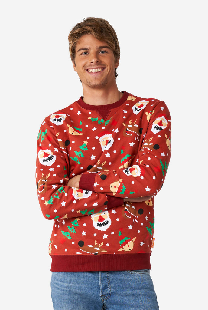 Man wearing red Christmas sweater with Christmas icons