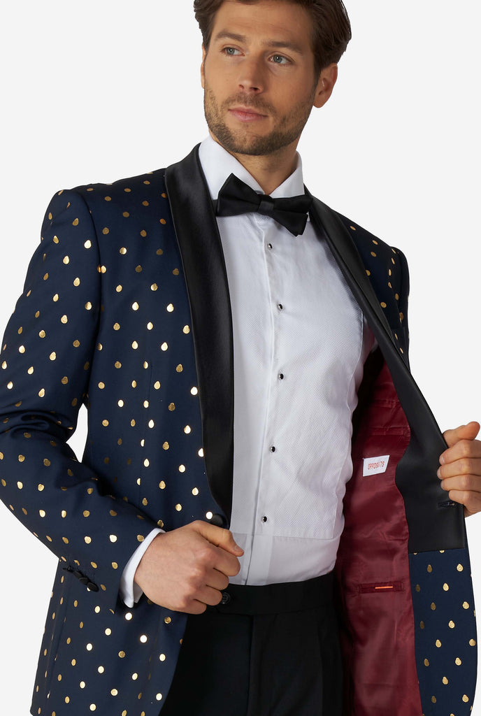 Man wearing blue tuxedo with golden dots