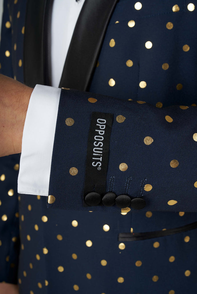 Man wearing blue tuxedo with golden dots, sleeve close up