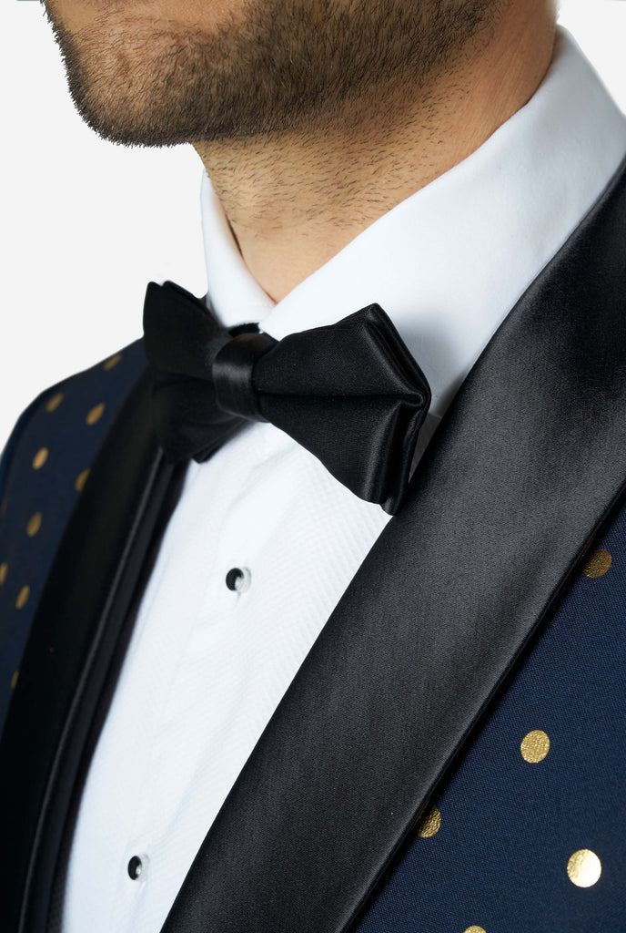 Man wearing blue tuxedo with golden dots, bow tie close up