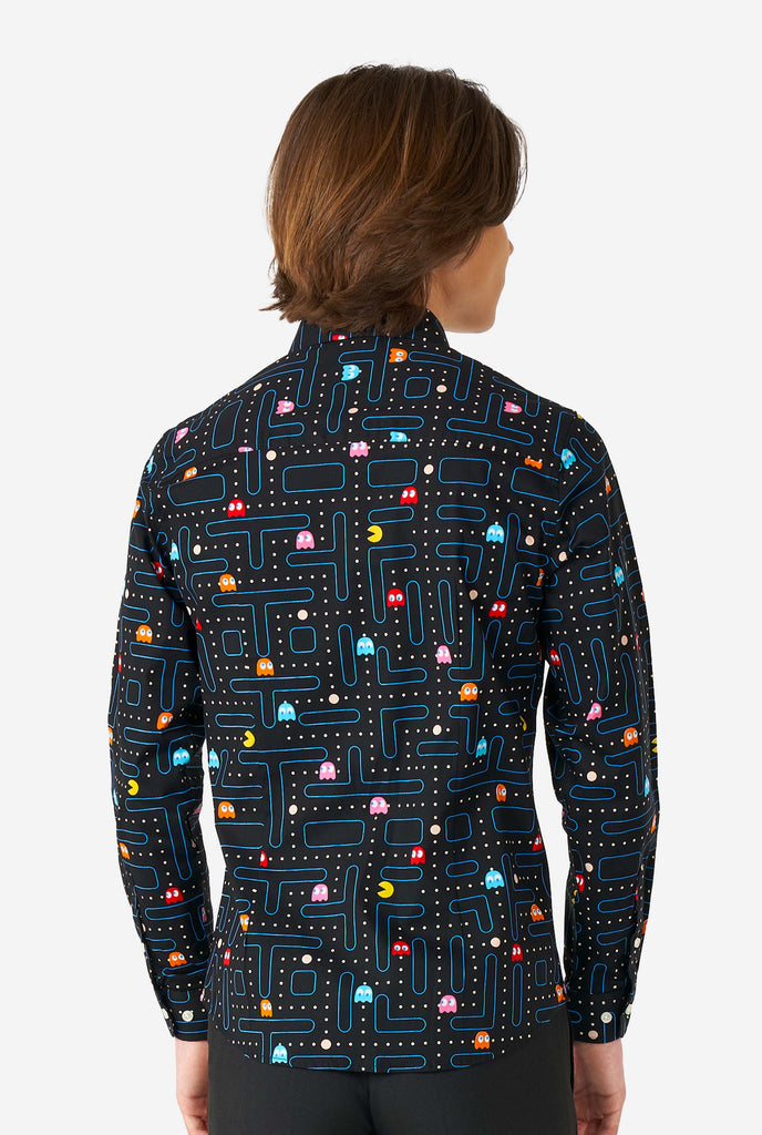 Teen wearing black dress shirt with Pac-Man print, view from the back