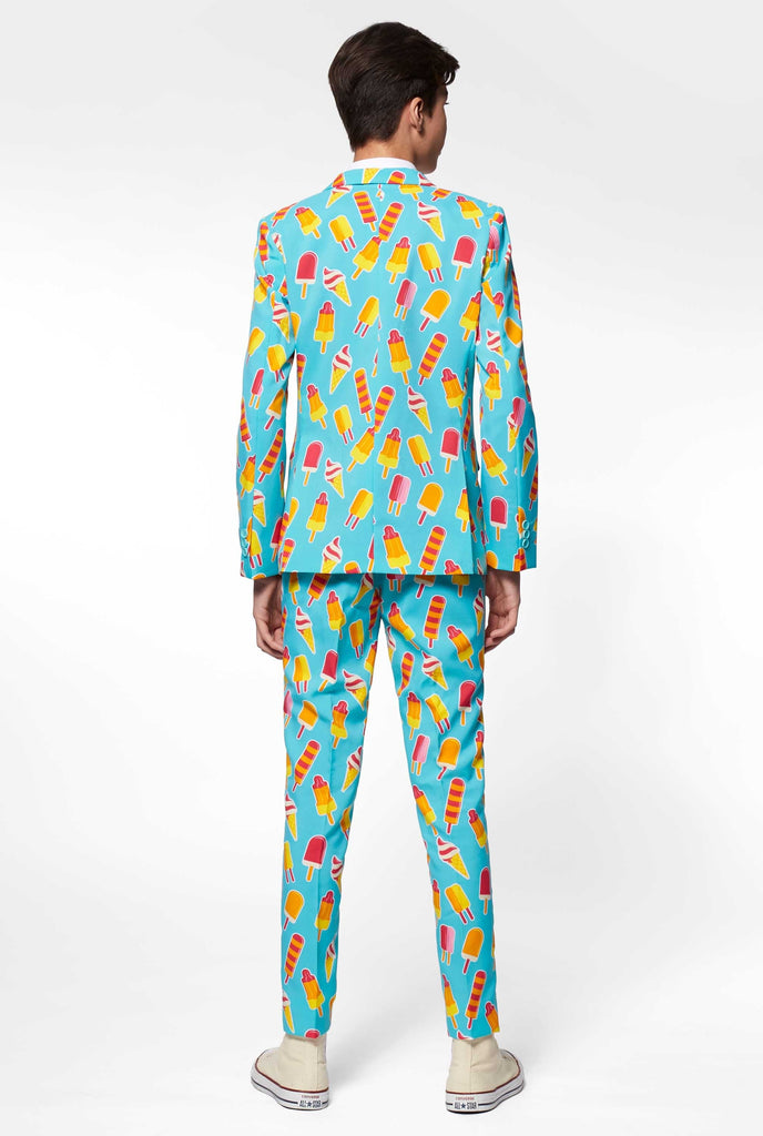 Teen wearing light blue formal suit with popsicle print, view from the back