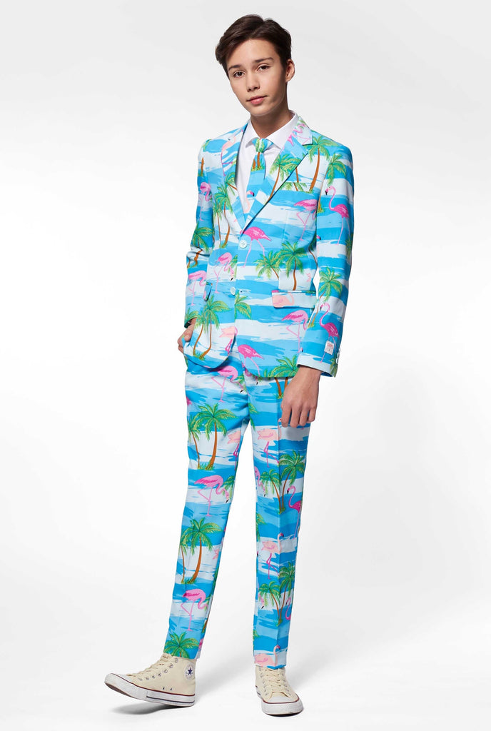 Teen wearing light blue suit with flamingo palm tree print