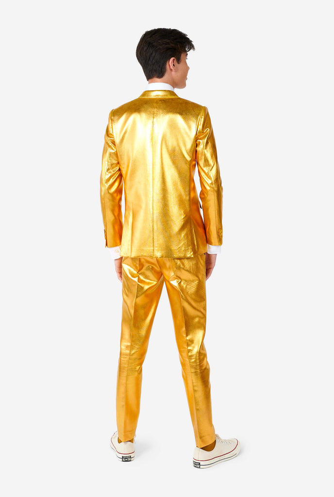 Teen wearing formal golden colored suit, view from the back