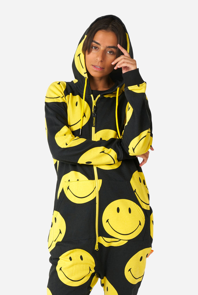 Woman wearing black onesie with yellow smiley print