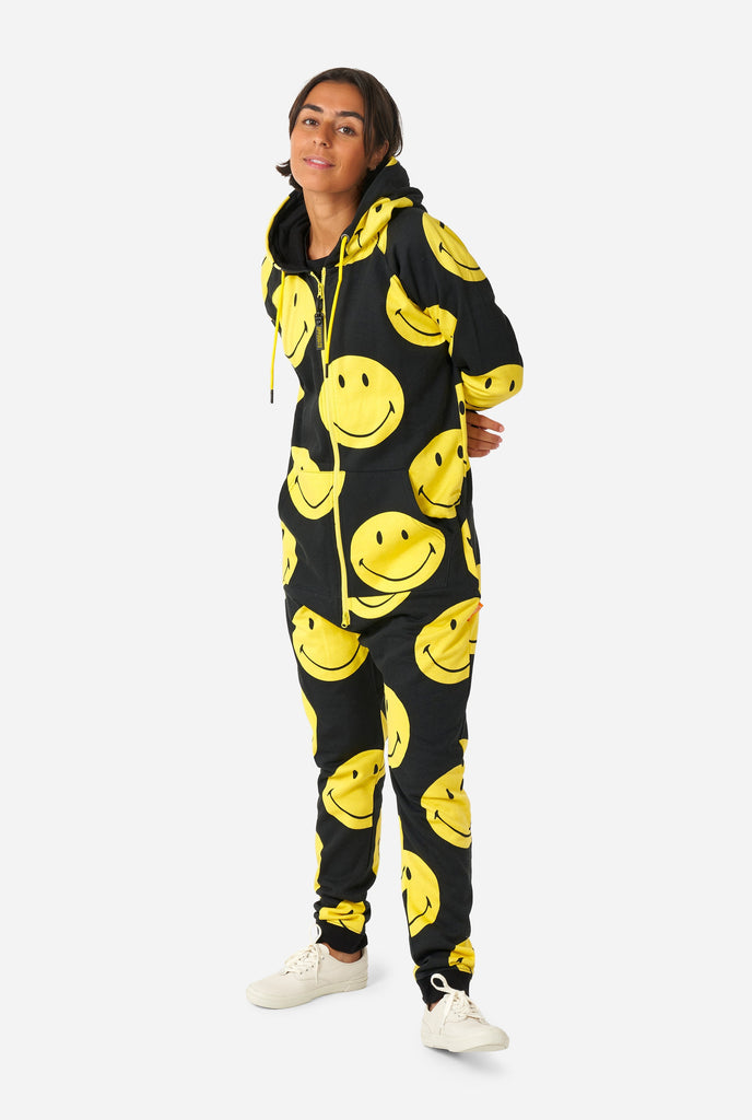 Woman wearing black onesie with yellow smiley print