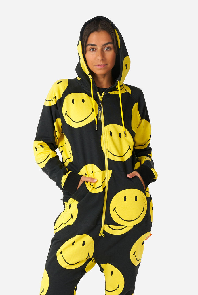 Woman wearing black onesie with yellow smiley print