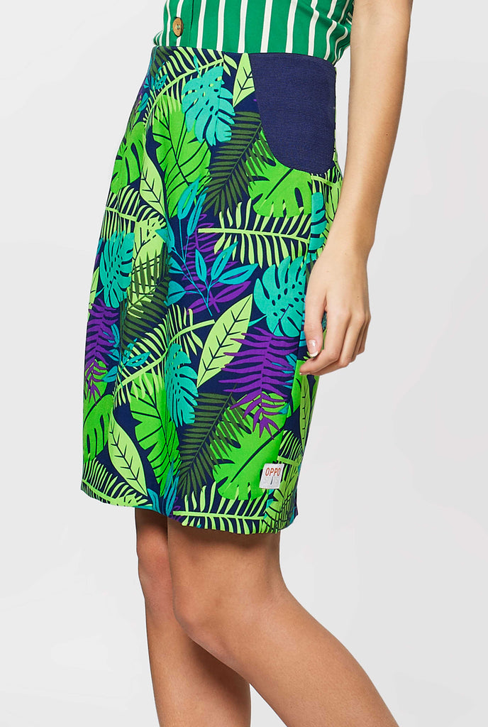 Woman wearing suit with green jungle leaves print, skirt view