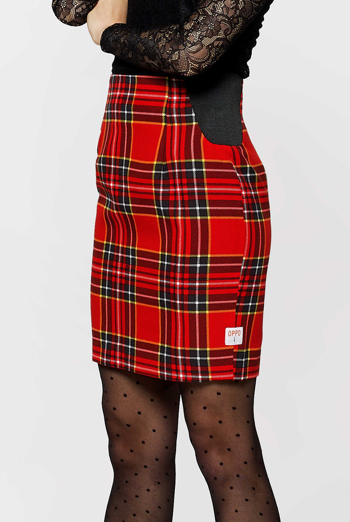 Woman wearing red tartan Christmas suit, skirt view