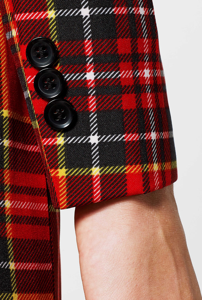 Woman wearing red tartan Christmas suit, sleeve close up