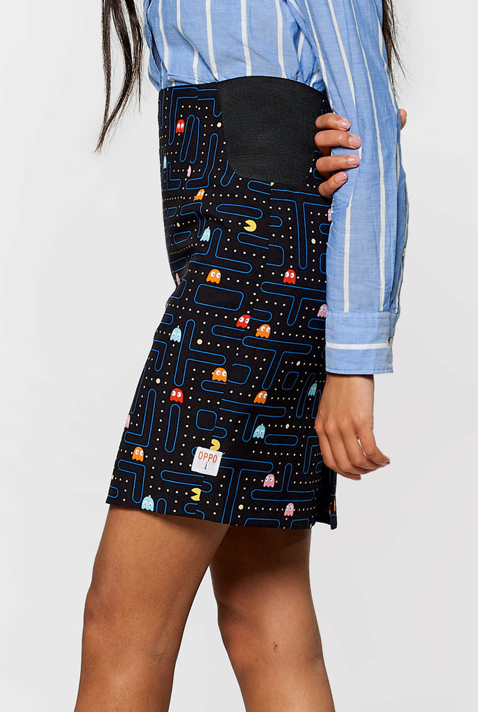 Woman wearing black dress suit with Pac-Man print, skirt close up