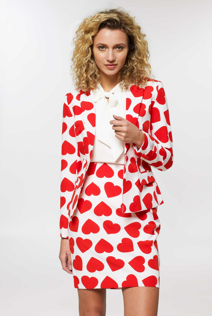 Woman wearing white Valentine's Day suit with red hearts