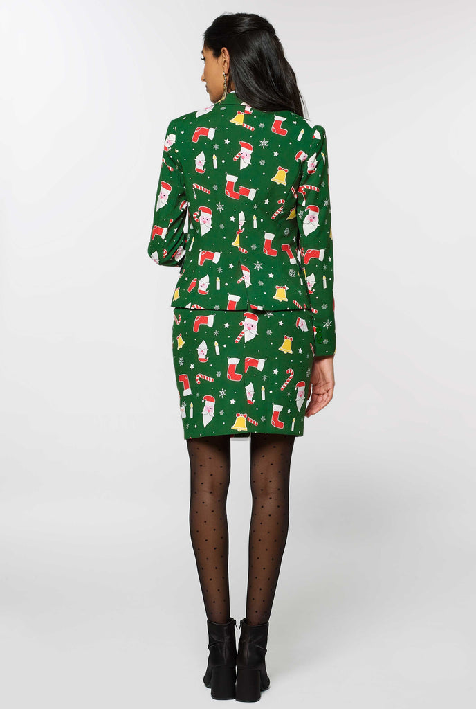 Woman wearing green suit with Christmas icons, view from the back